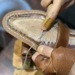 Inseaming in progress by a shoemaker.
