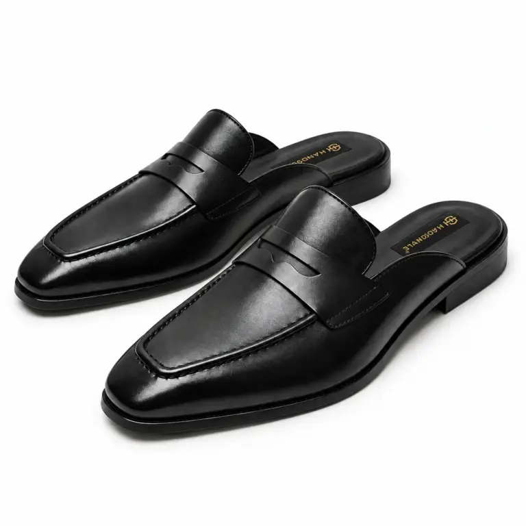 Black leather backless penny loafers for men, three-quarter view