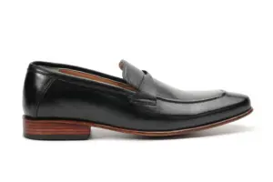 Side profile of black leather swirl-strap apron loafer