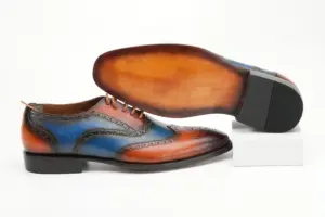 Cognac-blue wingtip Oxford shoe with its warm brown finished outsole