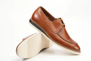 Angled view of cognac brown casual Derby shoes with cream ridged soles