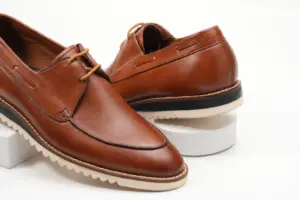 Close view of cognac brown apron-toe casual Derby shoes and open lacing