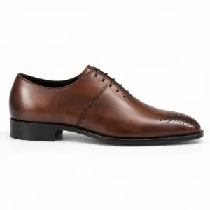 Side profile of a dark brown almond-toe Oxford showing a stitched panel seam and perforated toe medallion