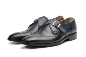 Pair of slate grey-black patina single monk strap shoes with wingtip toe and silver-tone buckle