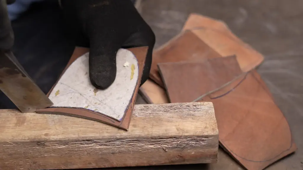 Hand welting technique — craftsman stitching welt by awl through leather upper and insole