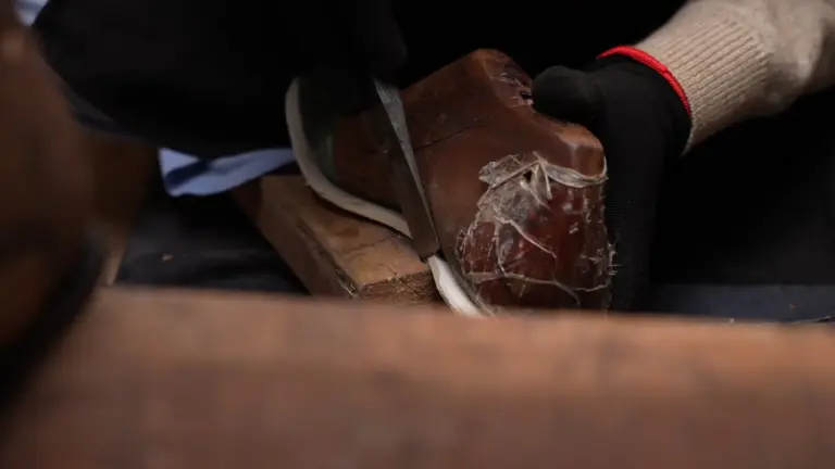 Handsole workshop bottom preparation during leather shoe construction
