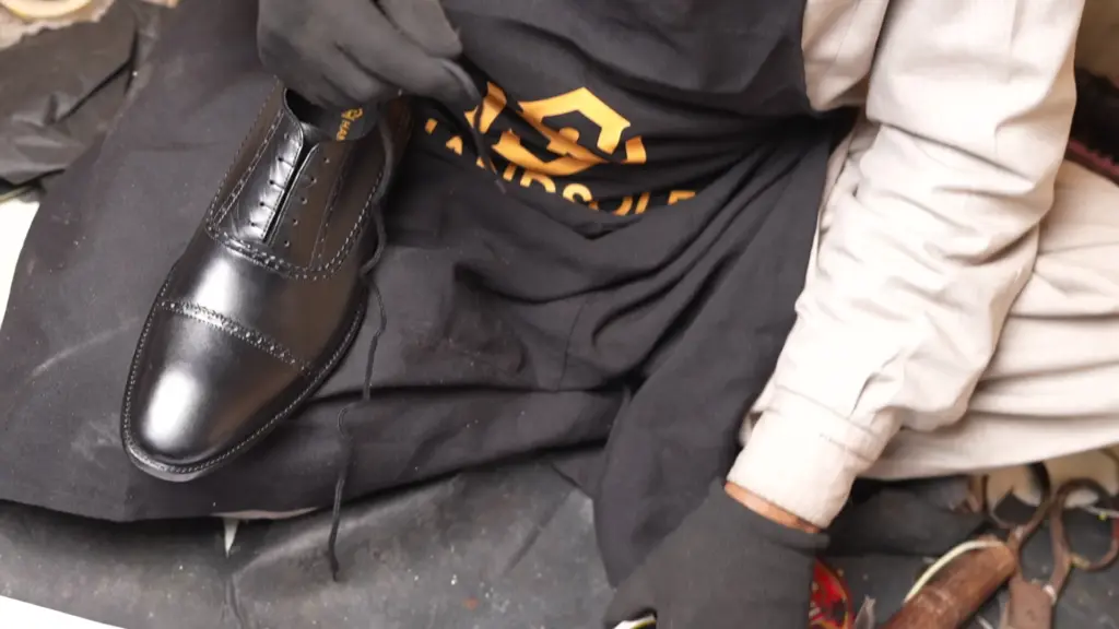 Hand-dyed leather patina — artisan applying Italian penetrating dye to handmade shoes