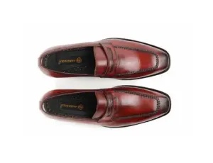 Overhead view of red-burgundy penny loafers showing Handsole branded insoles