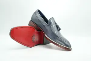 Grey Norwegian-welt tassel loafer with contrasting red-finished outsole and dark heel contact area