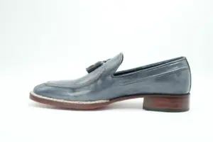Side profile of the slate-grey Norwegian-welt tassel loafer showing its brown-toned heel and stitched welt