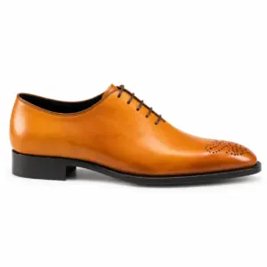 Side profile of the tan almond-toe Oxford showing smooth upper, closed lacing and toe medallion