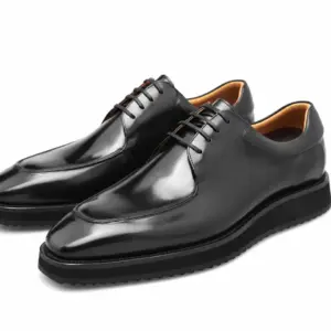 Close view of black hand-painted apron-toe Derby shoes with padded collars