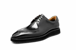 Black hand-painted apron-toe Derby shoe side view with black welt and ridged rubber sole