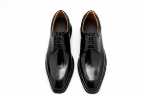 Top view of black hand-painted apron-toe Derby shoes showing padded tan leather-lined collars