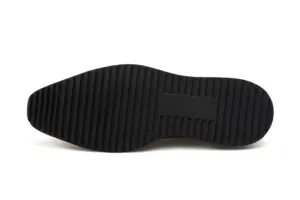Ridged black rubber outsole used on the hand-painted apron-toe Derby shoes