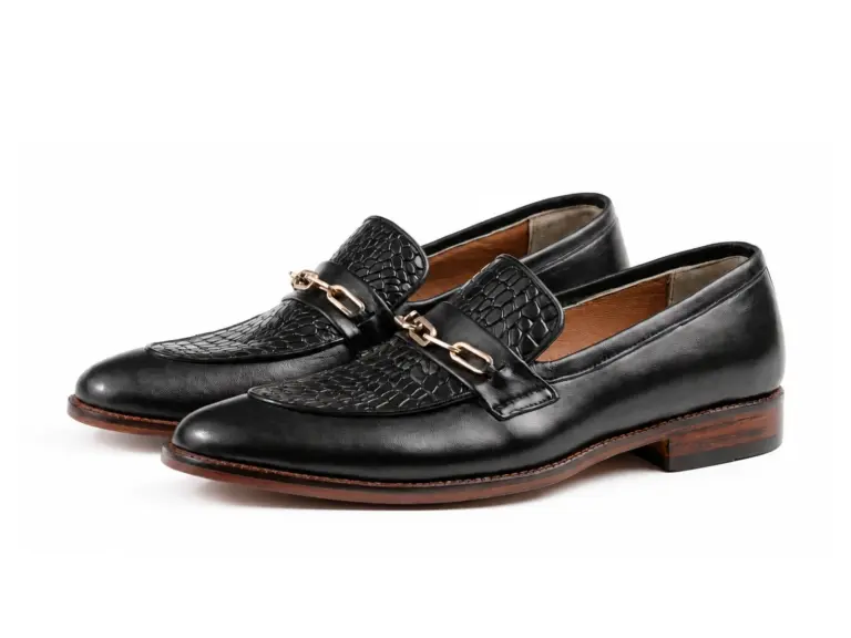 Black croc-pattern chain apron loafers in pair view on white background