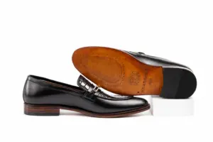 Black chain loafer side profile beside branded brown leather outsole