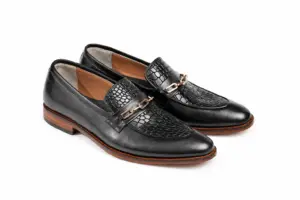 Three-quarter pair view of black leather chain loafers with textured aprons