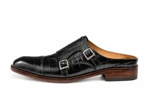 Outer side of a black croc-pattern mule showing two silver-tone buckles