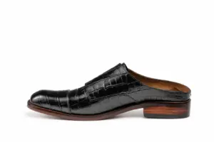 Inner side of a black croc-pattern square-toe mule with a low raised rear rim