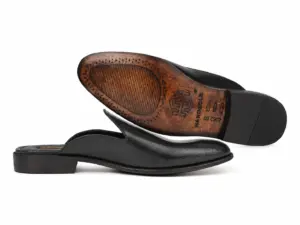 Black fine-texture mule side profile with the leather outsole facing forward