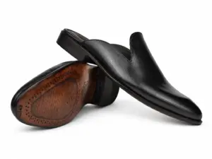 Black fine-texture plain mules showing the upper and brown leather outsole