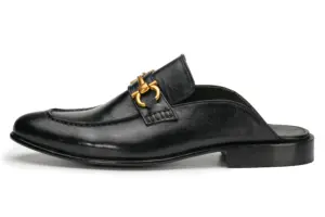 Black leather open-back mule with decorative buckle, detail view