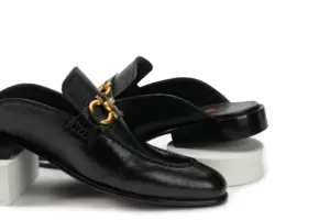 Black leather open-back mule with decorative buckle, pair view
