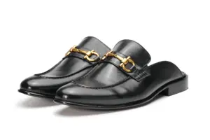 Black leather open-back mule with decorative buckle, sole view