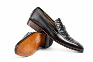 Black Reptile-Panel Horsebit Loafer: angled sole showing the brown outsole and dark heel.