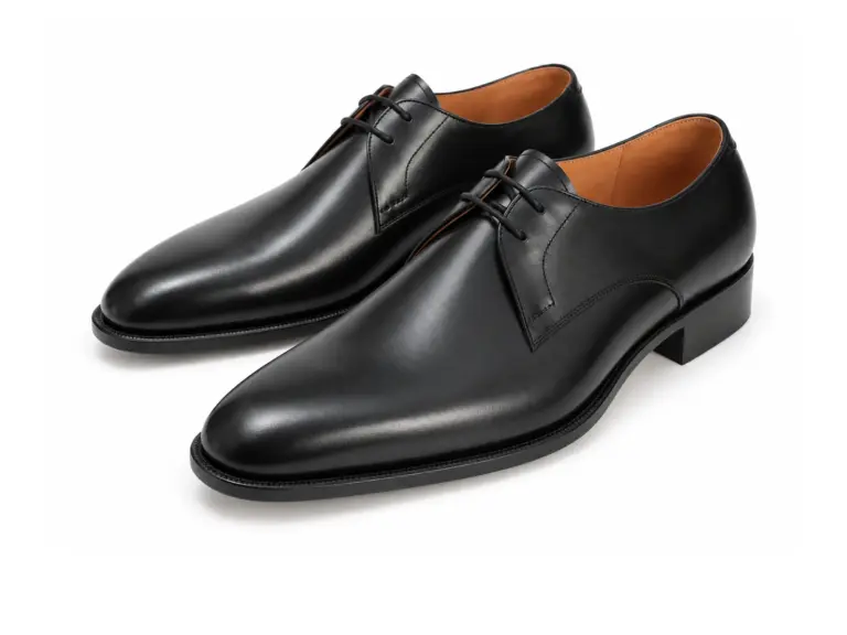 Black two-eyelet plain-toe Derby shoes, left-facing three-quarter pair
