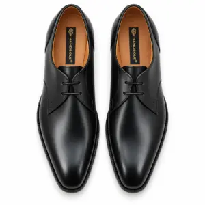 Top view of black plain toe Derby shoes with tan goat leather lining and Handsole footbed