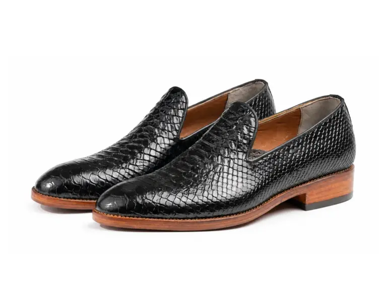 Pair of black reptile-pattern rounded-toe wholecut loafers