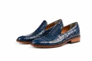 Pair of blue croc-pattern plain leather loafers on white background