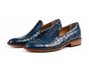 Pair of blue croc-pattern plain leather loafers on white background