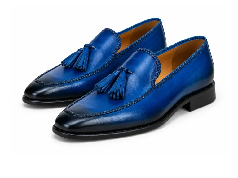 Blue patina braided-edge tassel loafers, left-facing three-quarter pair