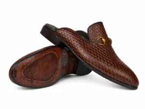 Brown-black basket-pattern horsebit mules showing the upper and leather outsole