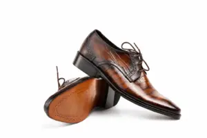 Brown-Black Striped Patina Plain-Toe Derby: angled sole showing the brown outsole and dark heel.
