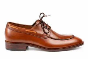 Brown moc toe shoes for men showing the apron seam and open lacing, inner side