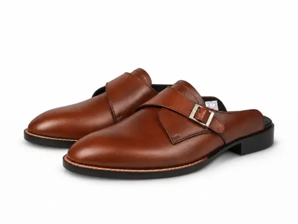 Brown leather single monk mules with contact shadows