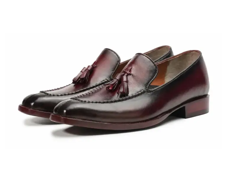 Pair of burgundy-black burnished men's tassel loafers, three-quarter view