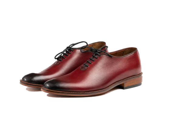 Three-quarter pair of oxblood wholecut Oxfords with black burnished toes and brown sole edges