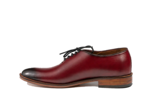 Left side profile of an oxblood wholecut Oxford showing its low lace opening and burnished toe