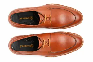 Top view of cognac apron toe Derby shoes with round toe and Handsole footbed