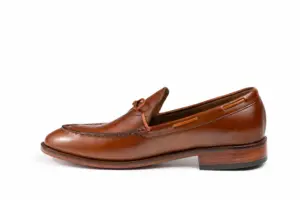 Opposite profile of cognac criss-cross apron loafer