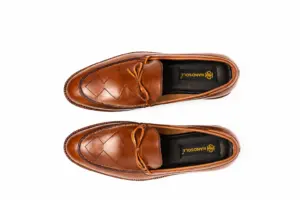 Overhead pair of cognac criss-cross apron tie loafers
