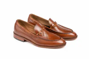 Three-quarter pair view of cognac leather tie loafers