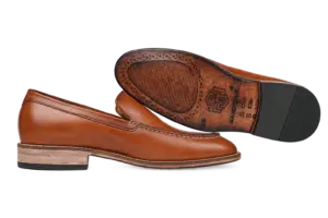 Cognac apron-toe loafers showing the leather outsole and heel