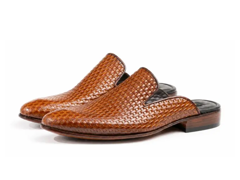 Pair of cognac woven-embossed plain mules on white background