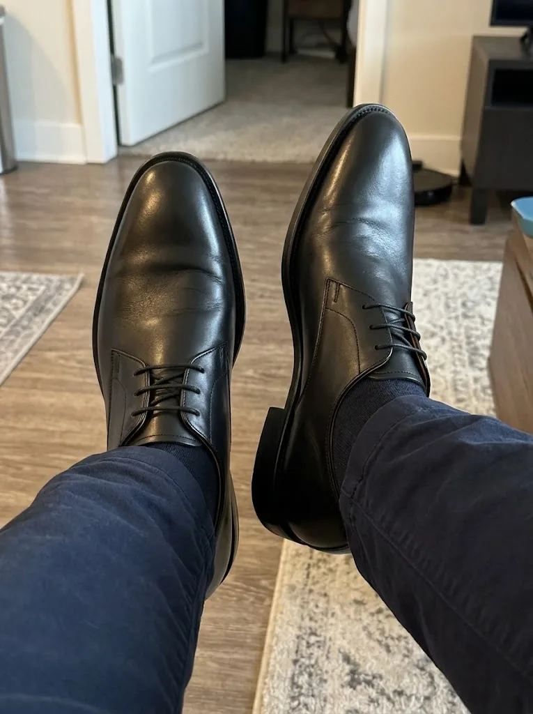 Customer wearing black plain toe Derby shoes with navy trousers